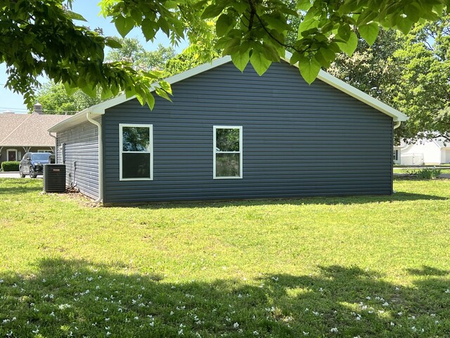 view of property exterior featuring a yard and central AC