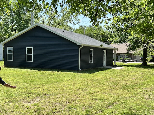 view of side of home featuring a yard