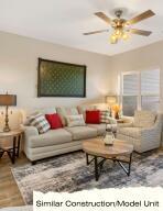living area with ceiling fan