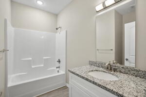 full bathroom featuring vanity, tub / shower combination, wood finished floors, and recessed lighting