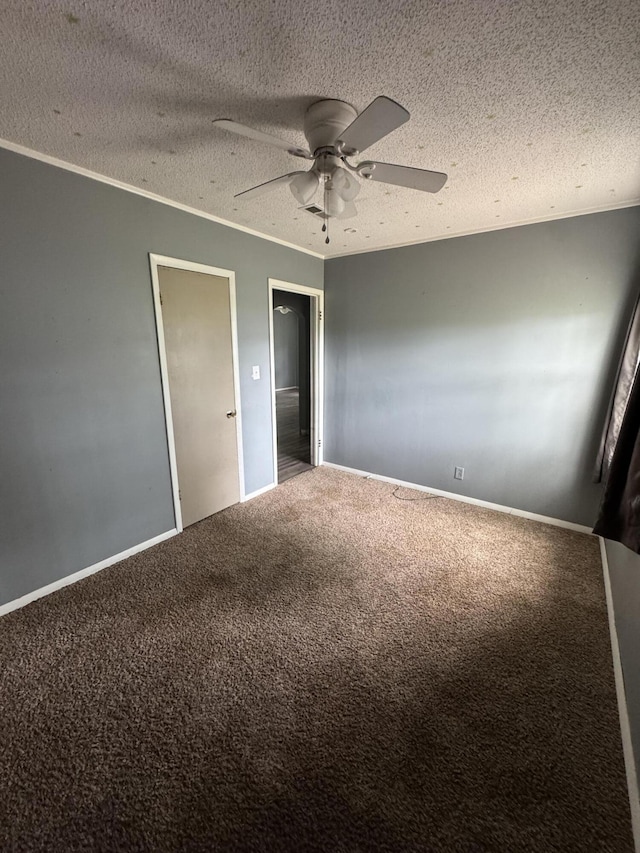 unfurnished bedroom with carpet floors, ornamental molding, ceiling fan, and a textured ceiling