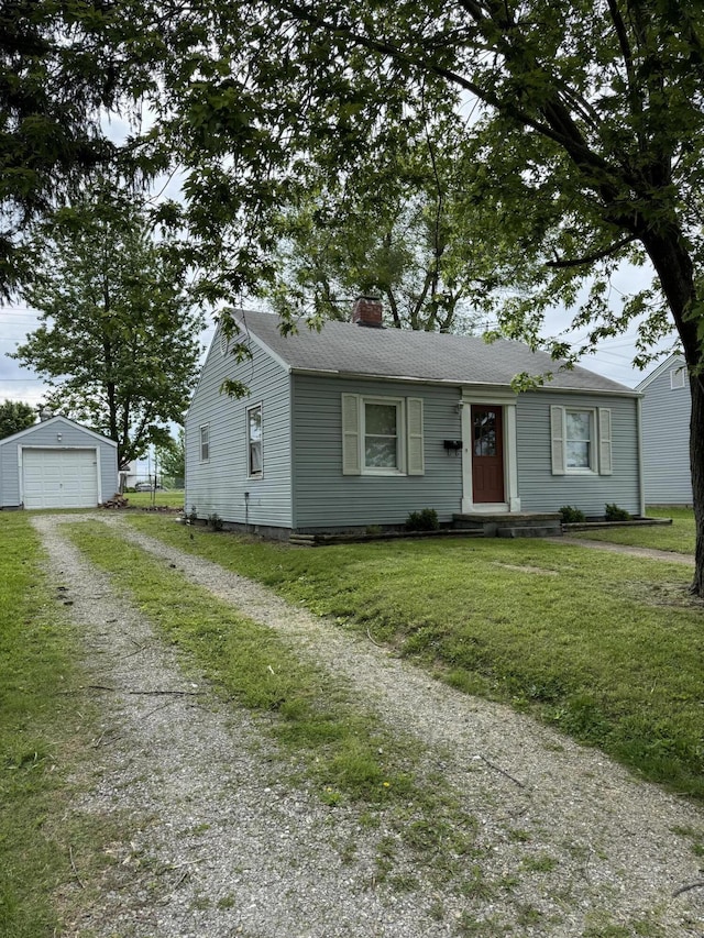 bungalow-style home with driveway, an outbuilding, a chimney, a garage, and a front yard