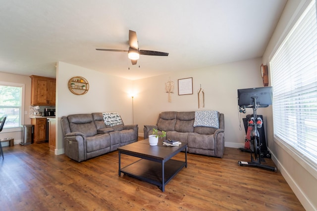 living area featuring ceiling fan, wood finished floors, and baseboards