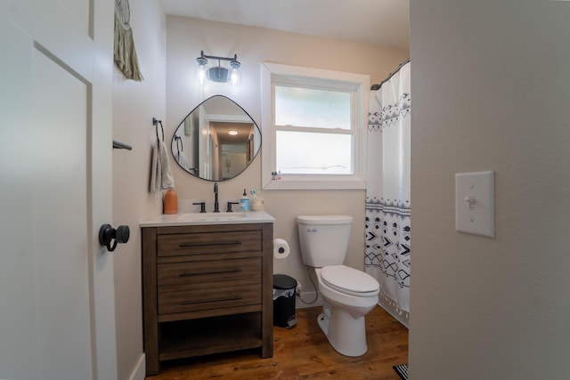 full bath featuring wood finished floors, toilet, and vanity