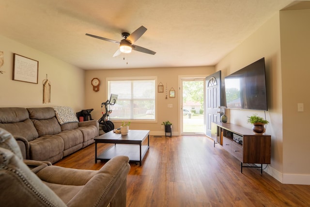 living room featuring ceiling fan, wood finished floors, and baseboards