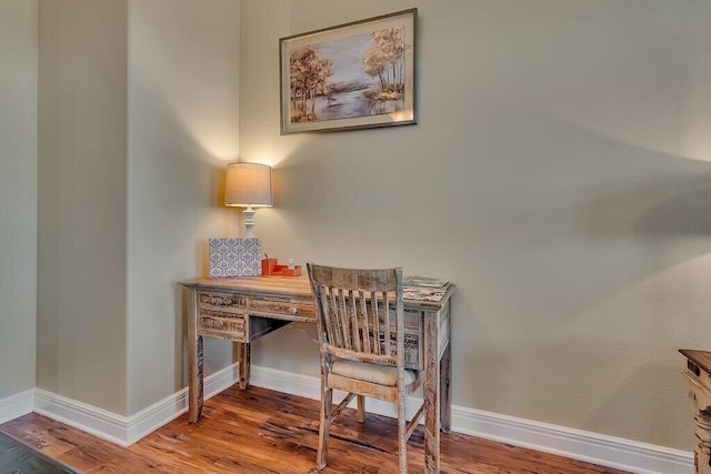 office space featuring wood finished floors and baseboards