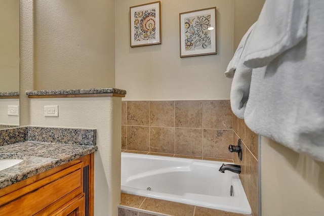 bathroom with tiled bath and vanity