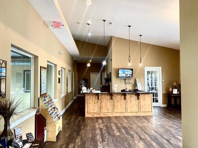 welcome area featuring a towering ceiling and french doors