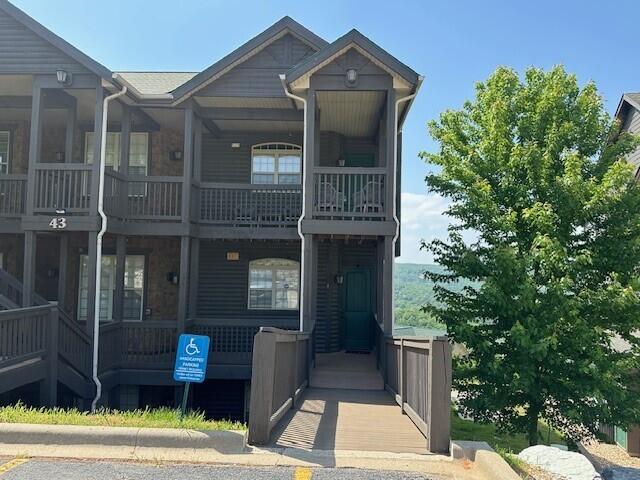 view of front of house featuring a balcony and covered porch