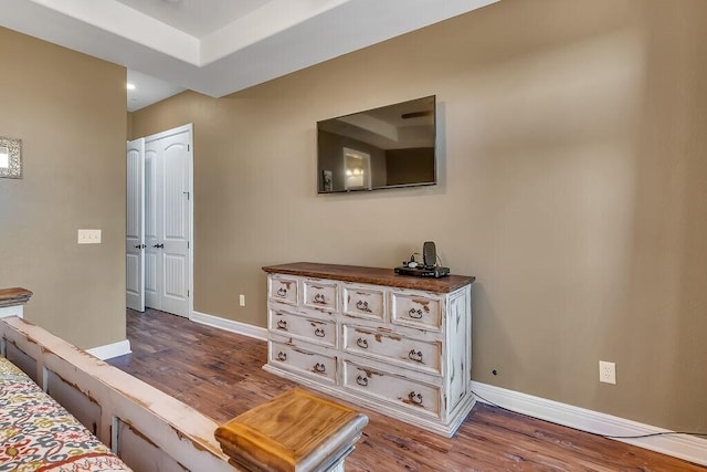 bedroom featuring wood finished floors, baseboards, and recessed lighting