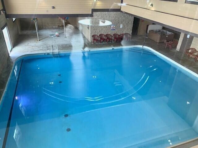 indoor pool featuring a patio area
