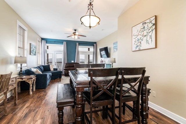 dining area with a ceiling fan, dark wood-style floors, and baseboards