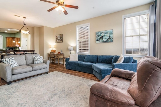 living room with a ceiling fan and wood finished floors