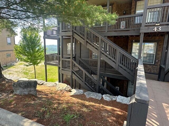 exterior space featuring stairway and a wooden deck
