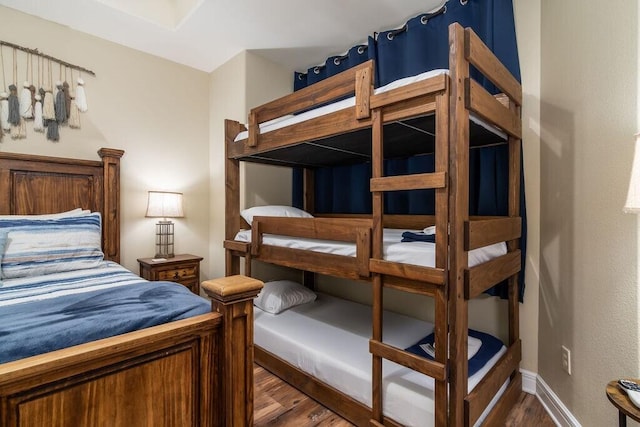 bedroom with wood finished floors and baseboards
