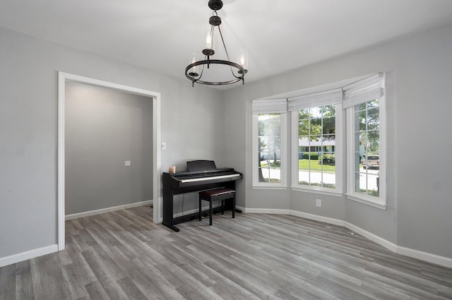 2857 E Linwood St, Springfield, MO 65804 - home office with a chandelier, wood finished floors, and baseboards