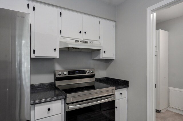 2857 E Linwood St, Springfield, MO 65804 - kitchen featuring appliances with stainless steel finishes, under cabinet range hood, white cabinetry, and dark stone countertops