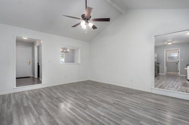 2857 E Linwood St, Springfield, MO 65804 - unfurnished living room featuring ceiling fan, beamed ceiling, wood finished floors, high vaulted ceiling, and baseboards