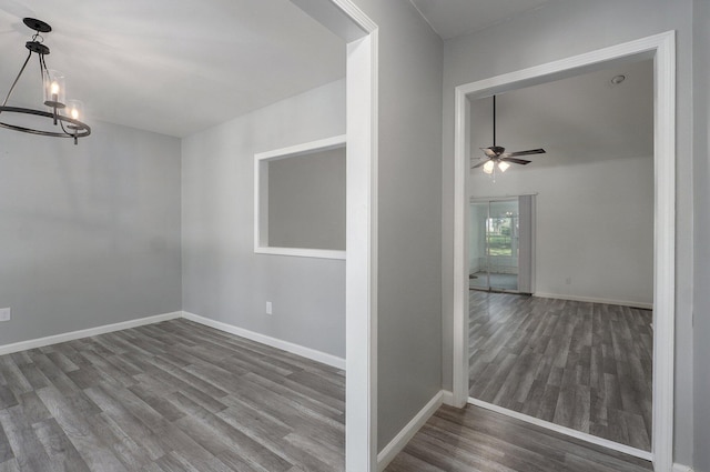 2857 E Linwood St, Springfield, MO 65804 - spare room with wood finished floors, a chandelier, a ceiling fan, and baseboards