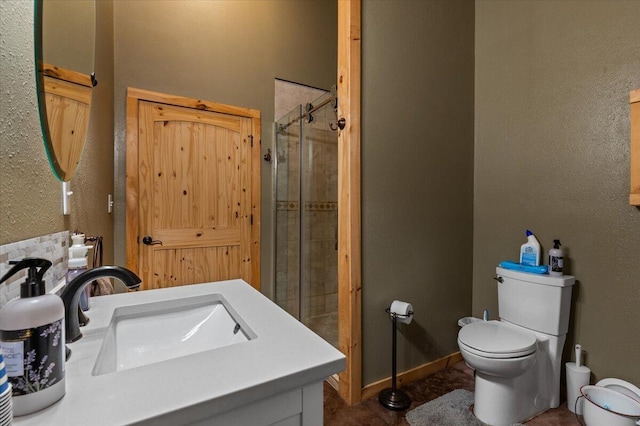 full bathroom featuring a sink, a shower stall, and toilet