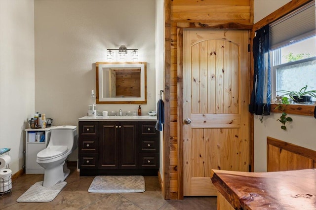 bathroom featuring toilet, vanity, and tile patterned flooring