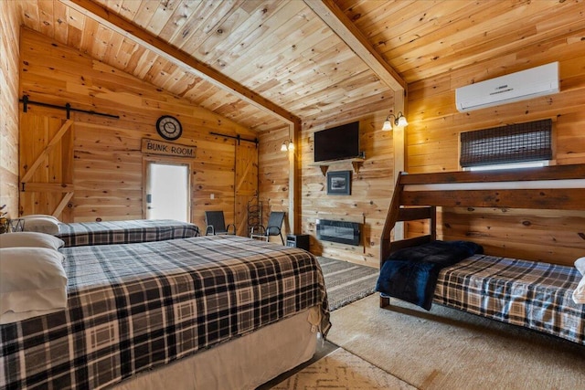 carpeted bedroom featuring a wall unit AC, wood ceiling, wood walls, a barn door, and a glass covered fireplace