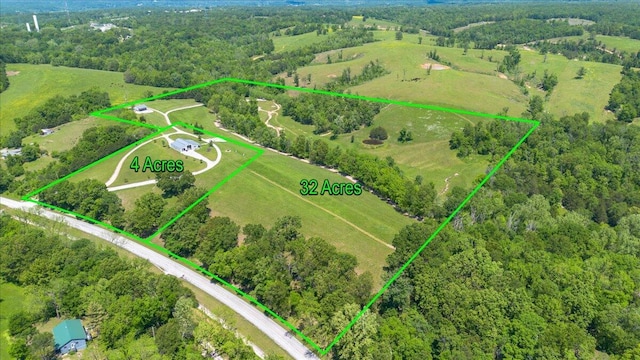 aerial overview of property's location with property parcel outlined and a heavily wooded area
