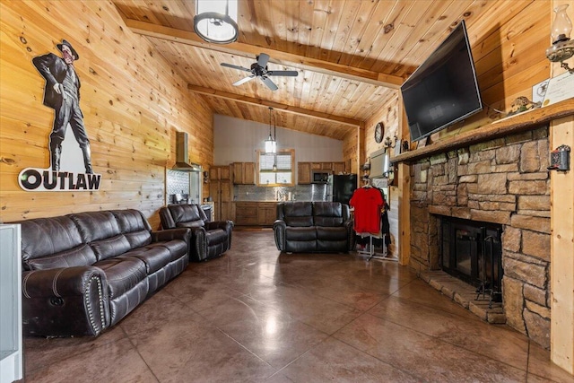 living room featuring wood walls, wooden ceiling, a ceiling fan, a fireplace, and finished concrete floors