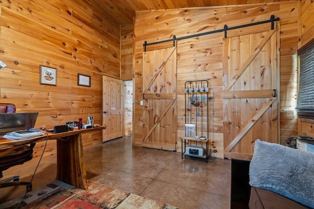 office space featuring a barn door, wood walls, and wood ceiling