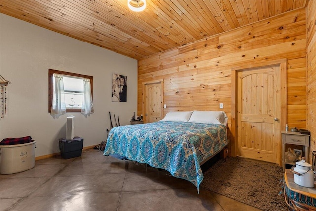 bedroom featuring wooden walls, concrete floors, wood ceiling, and baseboards