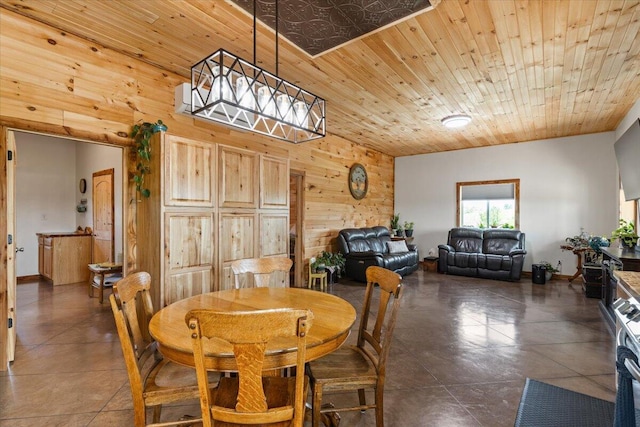 dining room with wood walls and wooden ceiling