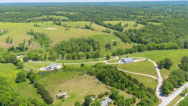 view of property location with a forest and rural landscape