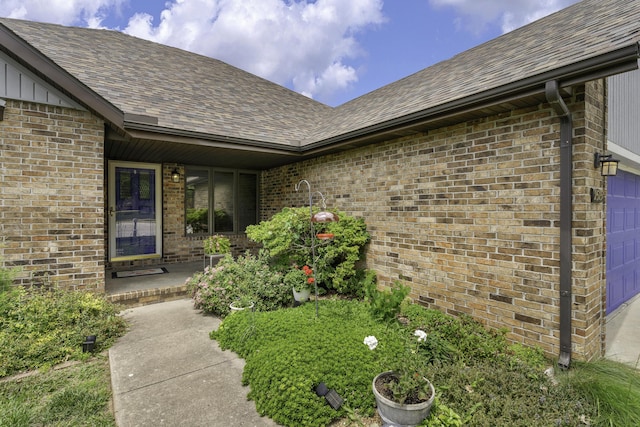 2515 S Laurel Ave, Springfield, MO 65807 - property entrance with roof with shingles, brick siding, and an attached garage