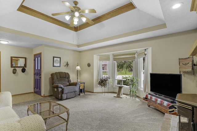 2515 S Laurel Ave, Springfield, MO 65807 - living room with baseboards, ceiling fan, a tray ceiling, and carpet