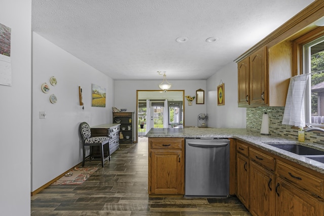 2515 S Laurel Ave, Springfield, MO 65807 - kitchen featuring dishwasher, brown cabinets, a peninsula, dark wood-style floors, and healthy amount of natural light