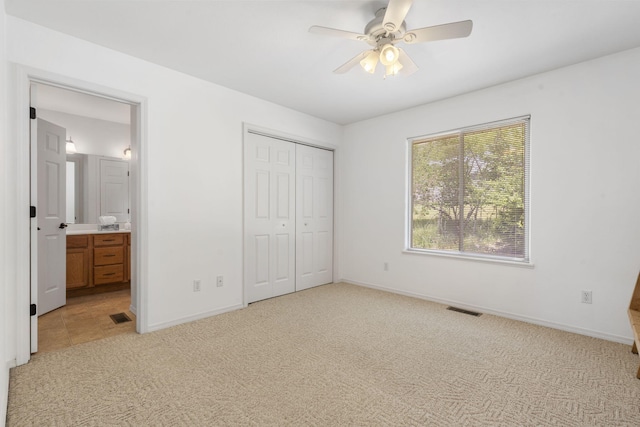 40 Overton Ct, Kimberling City, MO 65686 - unfurnished bedroom with light colored carpet, baseboards, a closet, connected bathroom, and a ceiling fan