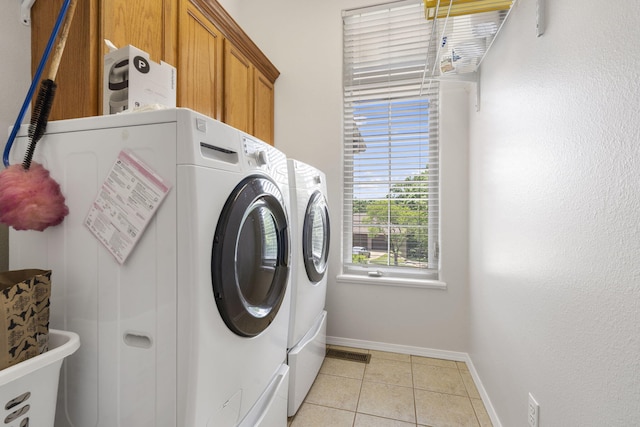 40 Overton Ct, Kimberling City, MO 65686 - laundry area featuring washing machine and clothes dryer, baseboards, cabinet space, and light tile patterned floors