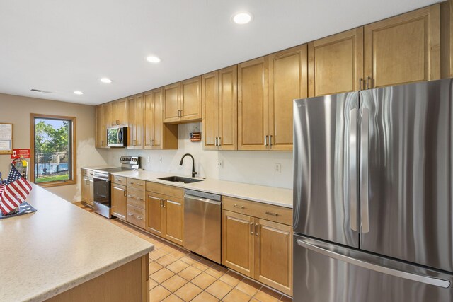 40 Overton Ct, Kimberling City, MO 65686 - kitchen featuring appliances with stainless steel finishes, a sink, light countertops, light tile patterned flooring, and recessed lighting