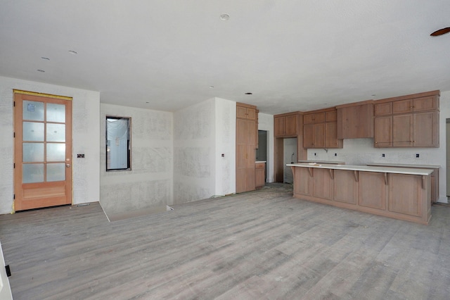 2937 W Edward St, Springfield, MO 65810 - kitchen featuring light wood-style floors, light countertops, open floor plan, and a kitchen bar