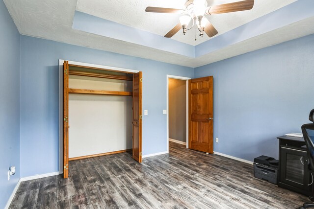 1888 S High Rdg, Nixa, MO 65714 - unfurnished bedroom with wood finished floors, a tray ceiling, baseboards, a ceiling fan, and a closet