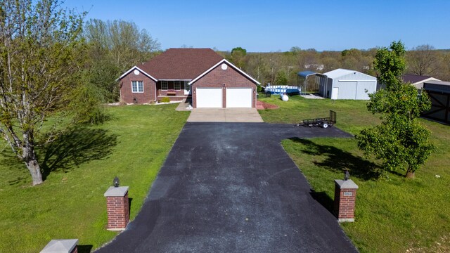 1888 S High Rdg, Nixa, MO 65714 - view of front of house featuring driveway, a front lawn, brick siding, and a garage