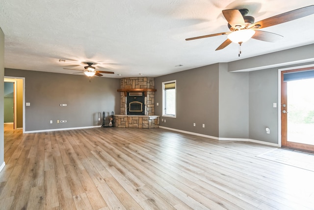 1888 S High Rdg, Nixa, MO 65714 - unfurnished living room with a ceiling fan, baseboards, light wood-style floors, and a stone fireplace