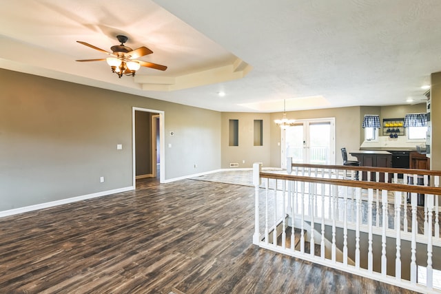 1888 S High Rdg, Nixa, MO 65714 - living area featuring baseboards, wood finished floors, ceiling fan, a tray ceiling, and a chandelier