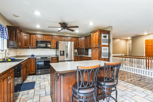 1888 S High Rdg, Nixa, MO 65714 - kitchen featuring black appliances, a sink, stone tile floors, a ceiling fan, and recessed lighting