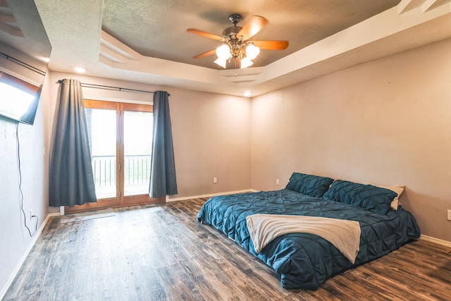 1888 S High Rdg, Nixa, MO 65714 - bedroom with baseboards, wood finished floors, a raised ceiling, access to exterior, and a ceiling fan
