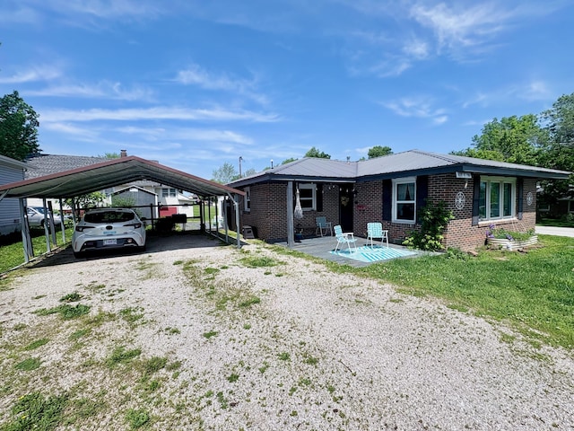 109 N Pine St, Marshfield, MO 65706 - view of front of house featuring a carport, driveway, and brick siding