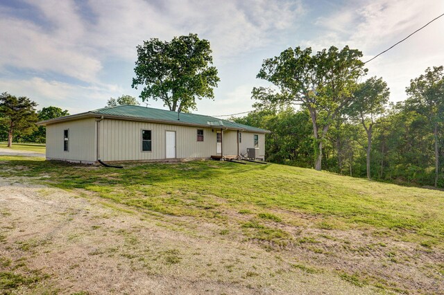 2121 E 505th Rd, Halfway, MO 65663 - rear view of house featuring a lawn, metal roof, and central AC unit