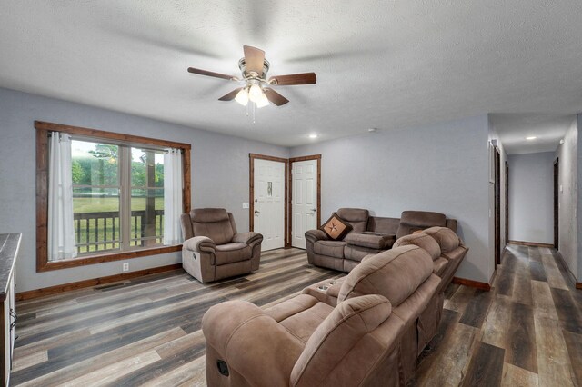 2121 E 505th Rd, Halfway, MO 65663 - living area featuring ceiling fan, wood finished floors, baseboards, and a textured ceiling