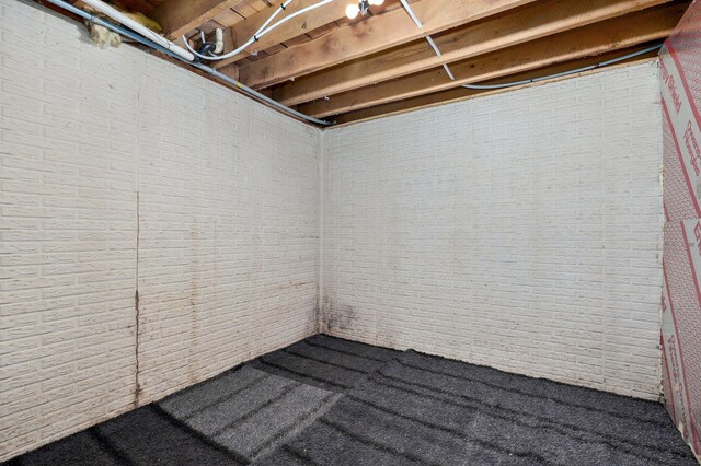 2121 E 505th Rd, Halfway, MO 65663 - unfinished below grade area featuring brick wall and carpet floors