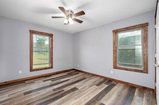 2121 E 505th Rd, Halfway, MO 65663 - empty room with wood finished floors, baseboards, and a ceiling fan